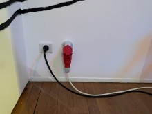 A German outlet is replaced with a French one and power to the track lights is re-routed.